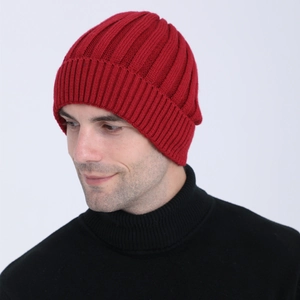 Detail of burgundy vertical striped knit beanie with fleece lining on male model