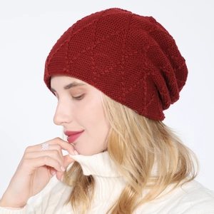 Detail view of burgundy knitted beanie featuring a classic diamond lattice pattern