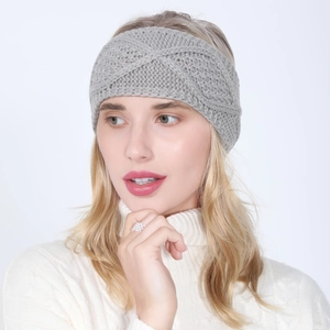 Detail of grey knitted winter headband featuring a stylish cross-twist and cable pattern