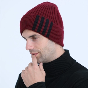 Detail of burgundy ribbed knit beanie with vertical black stripes for men's winter warmth
