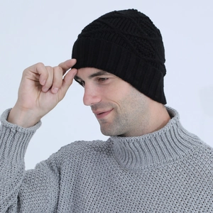 Close-up of black knitted beanie with diamond weave pattern and ribbed thermal cuff