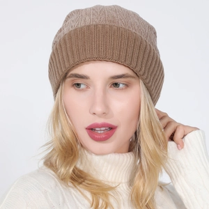 Detailed close-up of a dual-tone brown knitted beanie with a soft ribbed cuff design