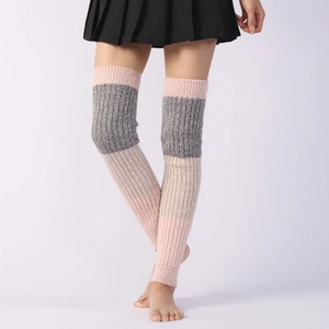 Detail of knitted over-knee leg warmers showing pink and grey color-block patchwork textures