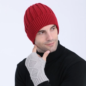 Detail of red vertical knit beanie and grey fingerless gloves for winter warmth