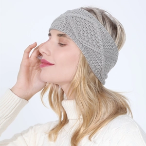 Detail of grey knitted headband with cable pattern on model for autumn winter style