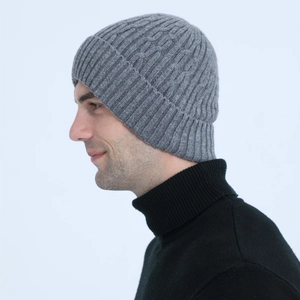 Detail view of men's grey cable knit beanie featuring thick fleece lining and ribbed cuff