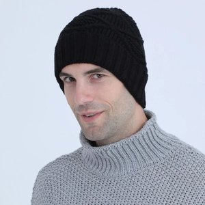 Detail of black knit beanie with ear flaps and textured weave on male model