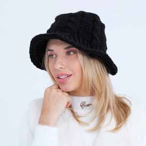 Close-up of black knitted bucket hat showing thick cable knit texture and wide brim