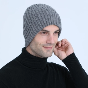 Macro shot of men's grey knit beanie with warm fleece lining and cable knit texture