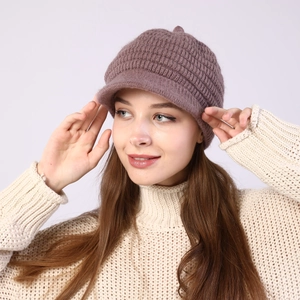 Detail of grey-pink striped knit peak cap with soft lining and warm wool texture