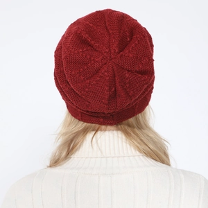 Detailed back view of deep red knitted beanie with thick textured ribbed pattern