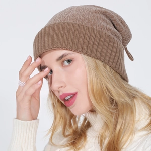 Detail view of brown knit beanie showing soft wool texture and wide ribbed cuff design