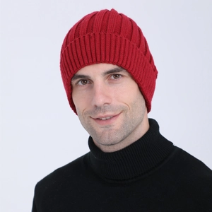 Detail view of red ribbed knit beanie worn by a model for winter warmth protection
