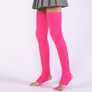 Detail view of neon pink ribbed knit stirrup leg warmers over the knee for dancing