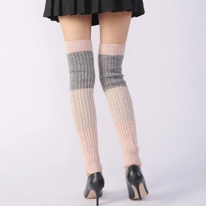 Detail of pink and grey striped knitted leg warmers showing ribbed texture and fit