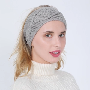 Detailed knit texture of grey cable-knit headband worn by model in white sweater