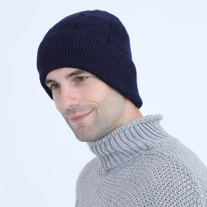 Detail of navy blue cable knit beanie showing thick ribbed texture for winter warmth