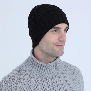 Detail of black knit beanie featuring a diamond pattern texture and ribbed cuff for winter