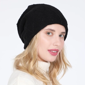 Detail showing black knitted beanie with waffle pattern texture and fleece lining