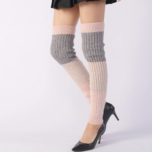 Detail of knitted striped leg warmers in pink and grey showing rib texture and fit