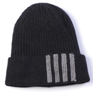Close-up of black ribbed knit beanie featuring thick grey vertical stripes on cuff