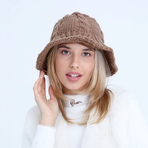 Detailed view of the chunky knit pattern and brown wool texture of this fisherman hat