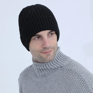 Detail of men's black cable knit beanie featuring thick fleece lining and ear protection