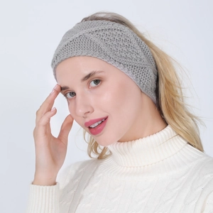 Detail of grey knitted headband with cross weave design and soft winter texture