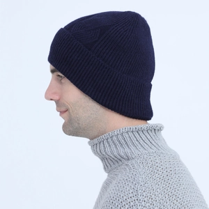 Detailed knit texture of a warm winter beanie featuring a vertical stripe pattern