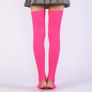 Macro detail of fluorescent pink ribbed knit over-knee leg warmers with stirrup heel design