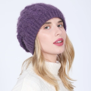 Close-up of women's purple knitted beanie showing thick cable stitch and fuzzy texture