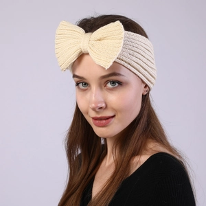 Beige knitted bow headband for women featuring a thick woven texture for winter warmth