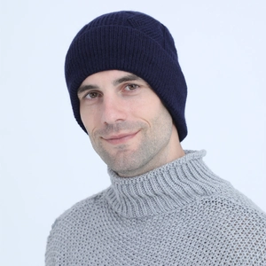 Detail of navy blue cable knit beanie featuring ribbed cuff and soft wool texture