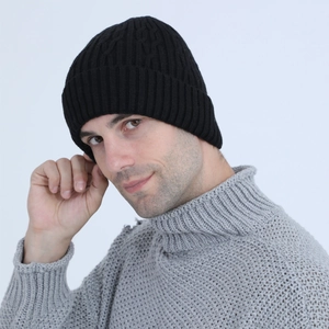 Close-up of men's black knit beanie with cable pattern and ribbed fold-over cuff