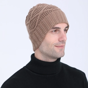 Detailed knit texture of a brown winter beanie featuring warm jacquard diamond patterns