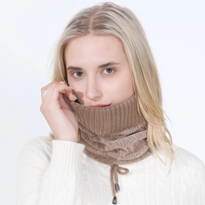 Detail of brown cable knit neck warmer featuring adjustable drawstring and metal toggles