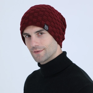 Close-up of deep red basket-weave knit beanie with fleece lining and logo patch