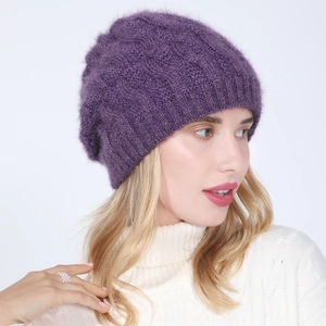 Detail of purple knitted beret with twist pattern and gold silk on white sweater