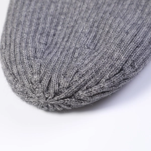Detailed macro view showing the thick ribbed knit texture and top stitching of the gray beanie