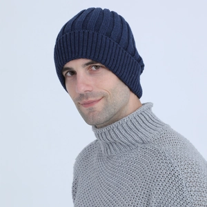 Detail of dark blue ribbed knit beanie featuring thick fleece lining and folded cuff