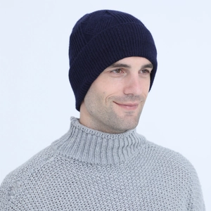 Detailed knit texture of a navy blue cable stitch beanie for men with warm ribbed design