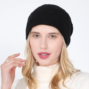 Detail view of black knit beanie texture and soft thermal diamond mesh weave on a model