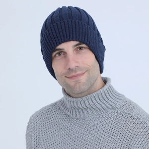 Detailed close-up of dark blue ribbed knit beanie with thick thermal wool texture