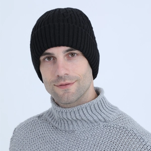Detailed close-up of a men's black cable knit beanie with warm fleece lining for winter