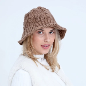 Detailed knit texture of a brown winter bucket hat with a thick cable pattern