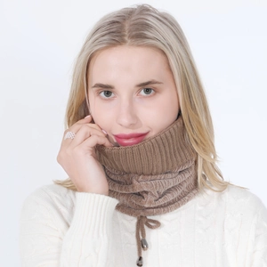 Detail of dark brown knitted neck warmer with drawstring and metallic silver tips