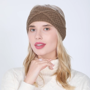 Detail of dark brown knitted twist headband with thick textured cable knit pattern