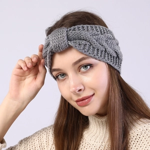 Dark grey knitted twist headband for women providing warmth and style during winter