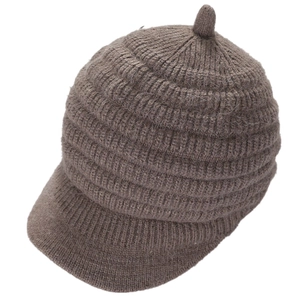 Detail of brown ribbed knit beanie with visor showing warm thick yarn texture