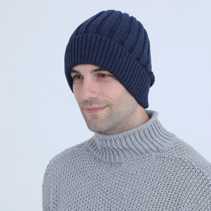 Close-up of navy blue vertical striped knit beanie with folded cuff on a male model